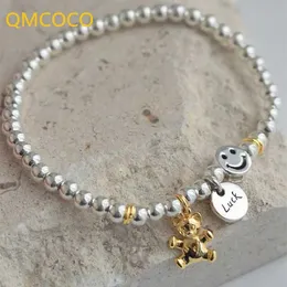 Beaded QMCOCO unik kreativ silverfärgad rund pendling leende ansikte björn runt pärla armband kvinnor nya koreanska modehandprydnader 240423