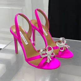 Aquazzura Rhinestones Bowknot Sandals Obcasy Slajdy otwarte palce krzyżowe Sandały Sandały 100 mm Damskie jedwabne jedwab i Vogue Evening Buty Letni Factory Factory Footwear