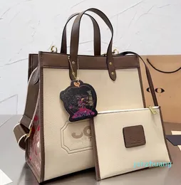 2024 designer bolsa feminina compras moda bolsa de lona botão de couro abertura e fechamento grande capacidade ombro compras