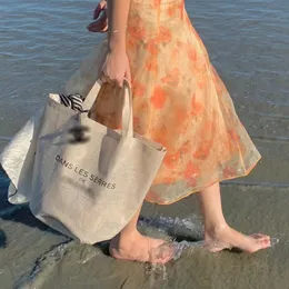 Mulheres designer sacos de compras vip presente camélia plantação comemorativa linho à prova dwaterproof água grande capacidade praia cesta bolsa ombro