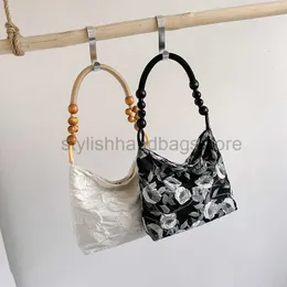 DrawString mode broderad tygväska för kvinnors 2023 sommar ny blomma hinkväska nisch design bärbar underarm bagstylishhandbagsstore