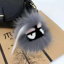 Fen luxuoso Fluffy Karl Genuine Raccoon Fur Pompom Monster Bag Bugs Charme Chaves de chaves de pelúcia de couro com borla de couro com borla