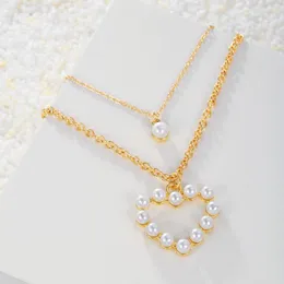 Anhänger Halsketten Nischendesign Persönlichkeit Zwei gesetzte Halskette herzförmige Perle Devil's Eye Trending für Frauen