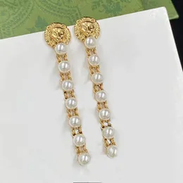 Pearl Sau Dangle brass material plated lion head luxury earrings. Swarovs perfect big pearl aretes, fashion brand designer earrings, designer jewels have gift stamps