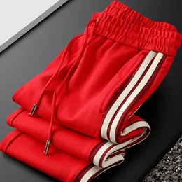 Mens Pants Charming handsome red casual sports pants mens bundle feet autumn and winter knitted webbing sweatpants 230324