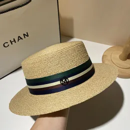 Europe and the United States M standard hand-woven straw hat women's fashion flat top hat summer sun visor hat beach hat.