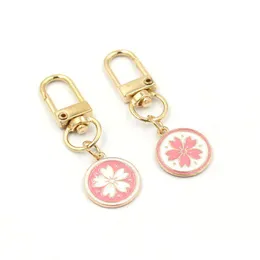Nyckelringar grossist rosa blommor skiva nyckelring japansk sakura blixtlås pl charm planerare charms tillbehör hangbag hängande hängen ke otvsh
