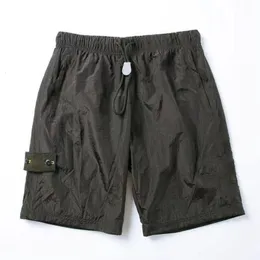 Pantalones cortos para hombre Y2k Stone Label Metal Nylon Función de malla Bolsillo tridimensional reflectante y Cargo para mujer 230703