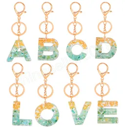 Mode harts 26 Engelska brev hänge nyckelkedja kvinnor akryl glitter guld alfabet nyckelhänge smycken gåvor