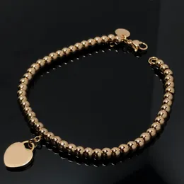 Braccialetto per ragazze a forma di cuore color pesca in oro massiccio 18 carati Braccialetto di perline a forma di cuore di design di nicchia di lusso leggero