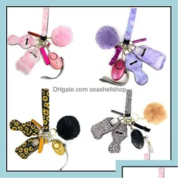 Jewelry 23 Colors 8Pcs Defense Keychain Set Alarm Pompom Keychains Hand Sanitizer Wrist Strap Lipstick Bottle Opener Whistle For Woman Dhepd