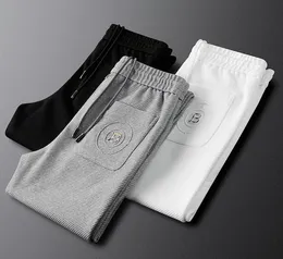 Męskie spodnie wiosna jesień mężczyźni swobodne spodnie sportowe sporne spodnie sportowe spodnie listowe drukowane spodnie uliczne azjatyckie rozmiar m5xl