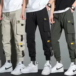 Calças masculinas finas streetwear calças casuais homens fitas harem calças de jogging masculino fino ajuste primavera calças de carga multibolsos calças femininas jx1 231010