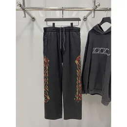 Pantaloni da maglione firmati Balencigaly Parigi inglese da uomo con lettera lavata con fiamma invecchiata Graffiti Guard sciolto unisex