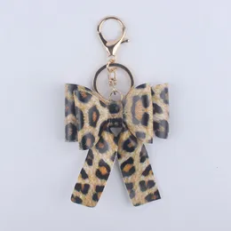 Portachiavi con ciondolo a fiocco Portachiavi in pelle PU Ciondoli Portachiavi per auto da donna Portachiavi Portachiavi Catena regalo Cartone animato Fiore colorato Leopardo Fashion Design Accessori di gioielli