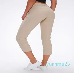 Morbido tessuto Nakedfeel Yoga Capris Allenamento Pantaloni sportivi Donna Coulisse in vita Fitness Pantaloni sportivi da corsa con due tasche laterali