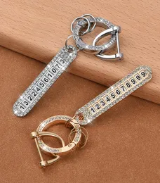Bil diamant nyckelring h￤nge med anti-f￶rlorad telefonnummer tallrik man och kvinnlig uts￶kt nyckelkedja h￤nge