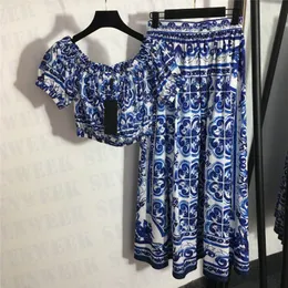 Camisetas de vestido de padrão vintage para mulheres projetam projetos retos de manga curta de manga curta Ladies Saias plissadas de cintura alta duas peças