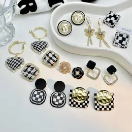 Autumn Charm winter black and white chessboard plaid silver needle earrings light luxury temperament niche design sense advanced