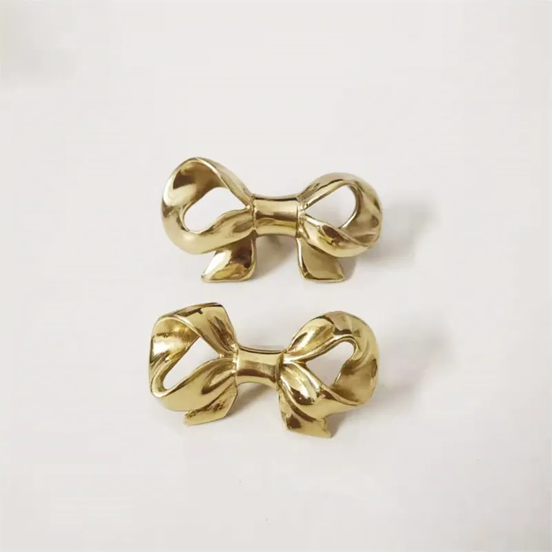 Bow Tie Shaped Brass Handle Cabinet Wardrobe Door Pulls Drawer Knobs Gold  Color Furniture Handles from Dhgate Other Door Hardware - price 5.92