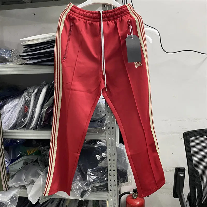 Red and green track pants sales