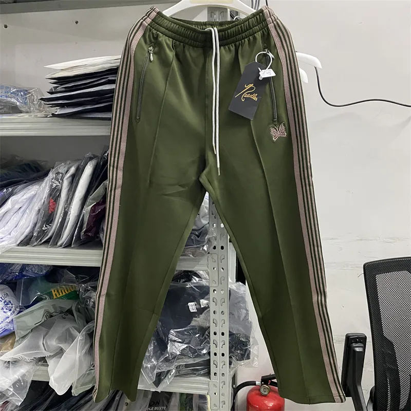 Men's green track pants with red stripe sale