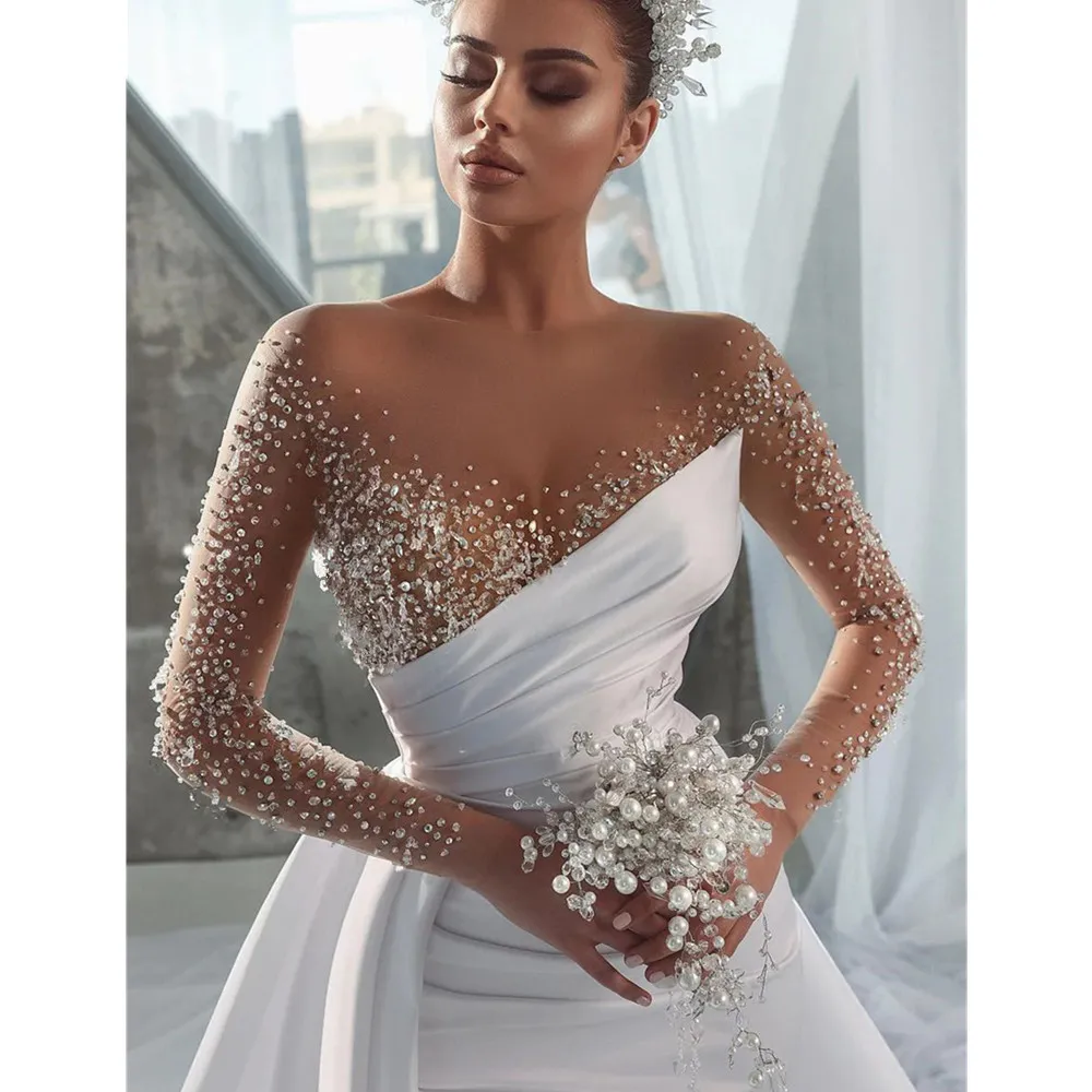 Modest African Arabic one shoulder wedding dress with Beading, Jewel Neckline, and Illusion Silhouette - Long Sleeves, Satin Fabric, Ruched Detailing Modest African Arabic one shoulder wedding dress with Beading, Jewel Neckline, and Illusion Silhouette - Long Sleeves, Satin Fabric, Ruched Detailing