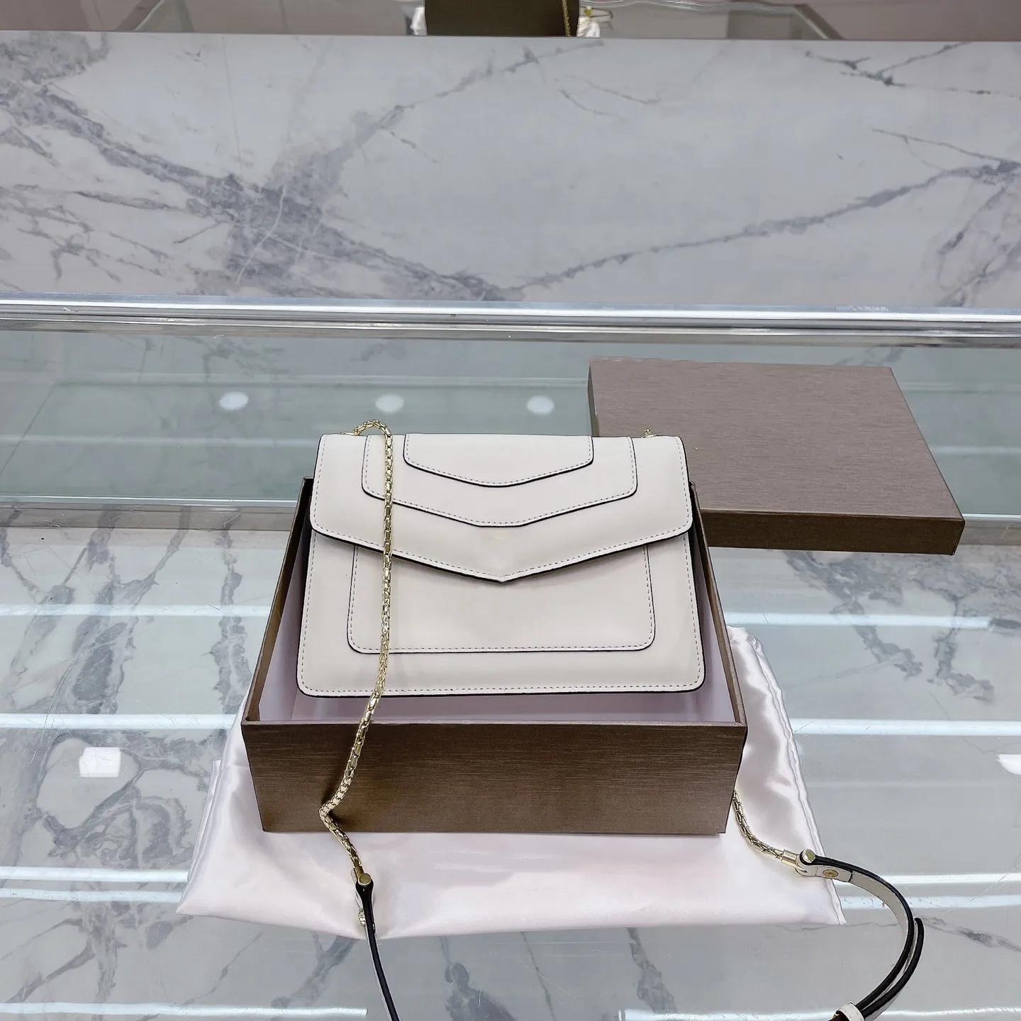 Designer bag store with snake clasp