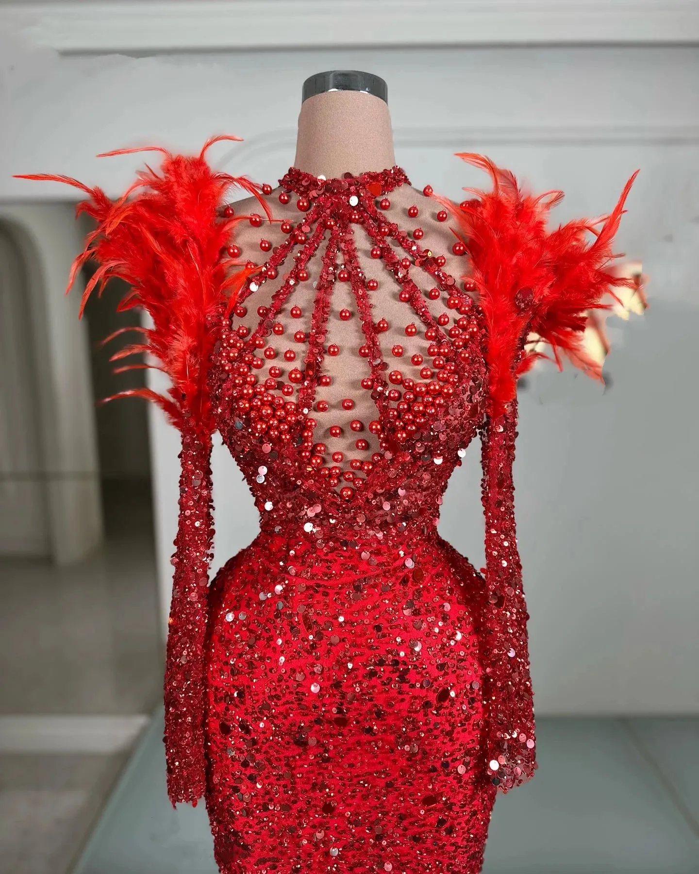 beaded dress with feathers Golden feather beaded dress with a structured winged collar