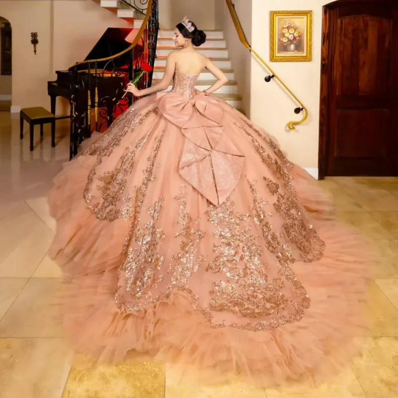 rose gold quince dress with bow Rose Gold Quinceanera Dress - 3D Flowers Sequined Ball Gown with Beaded Corset, Cape & Tassel Appliques